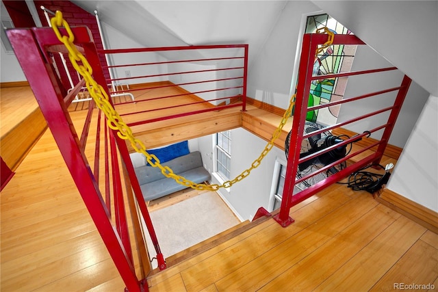 2627 Champa St, Denver, CO 80205 - stairway featuring vaulted ceiling and wood finished floors