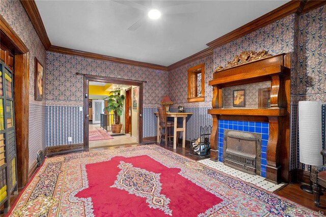 2627 Champa St, Denver, CO 80205 - living room featuring ceiling fan, crown molding, wallpapered walls, a tile fireplace, and wood finished floors