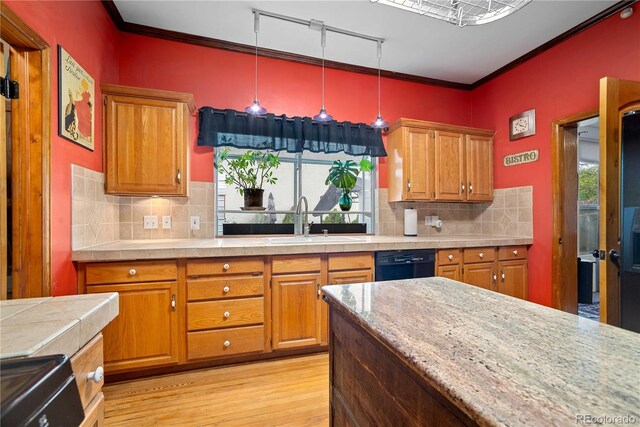 2627 Champa St, Denver, CO 80205 - kitchen with light wood-style flooring, black dishwasher, crown molding, brown cabinetry, and backsplash
