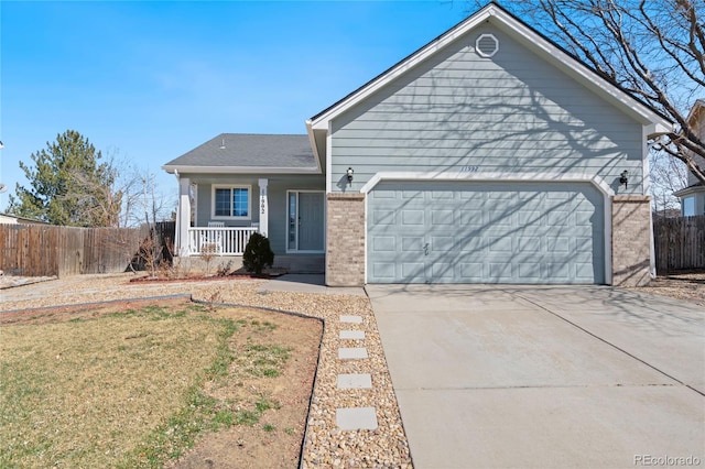 ranch-style home featuring a front yard, a garage, and covered porch