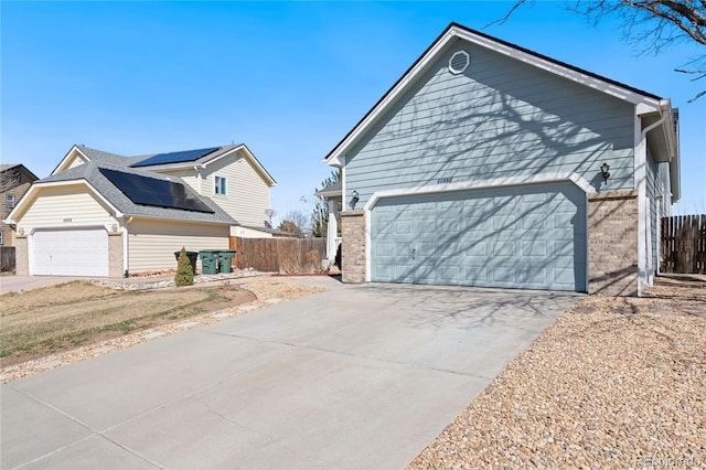 view of front of home with solar panels and a garage