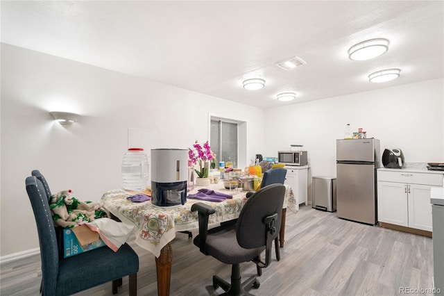 dining space featuring light wood-type flooring