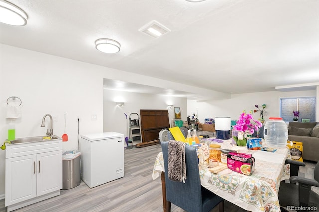 dining room featuring light hardwood / wood-style flooring and sink