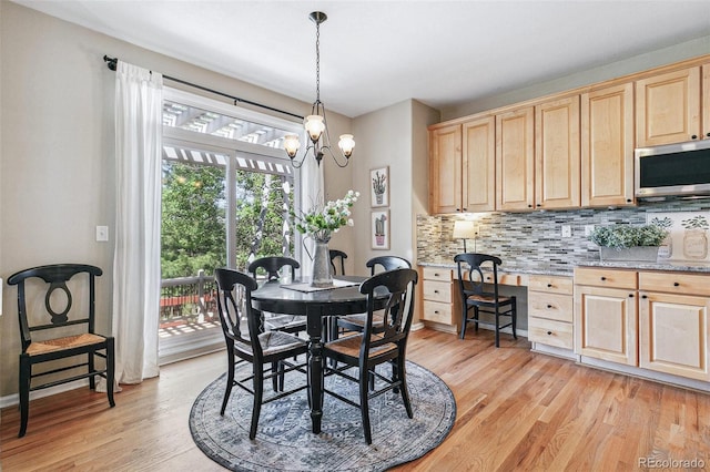 3411 Springbriar Dr, Castle Rock, CO 80109 - dining space featuring light wood-style floors and a chandelier