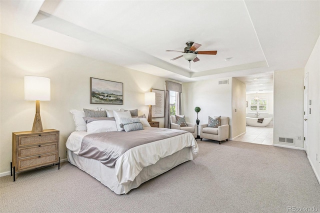 3411 Springbriar Dr, Castle Rock, CO 80109 - bedroom with a tray ceiling, multiple windows, light carpet, and baseboards