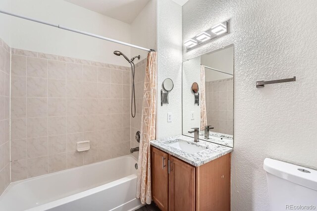 full bathroom featuring vanity, shower / bath combination with curtain, and toilet