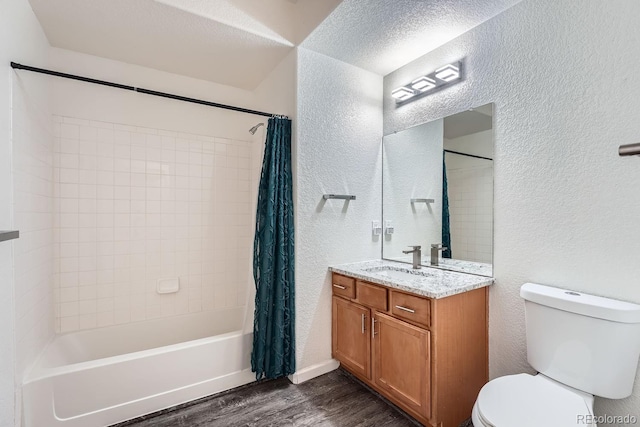 full bathroom with hardwood / wood-style flooring, shower / tub combo with curtain, vanity, and toilet