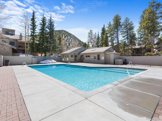 view of swimming pool with a mountain view and a patio area