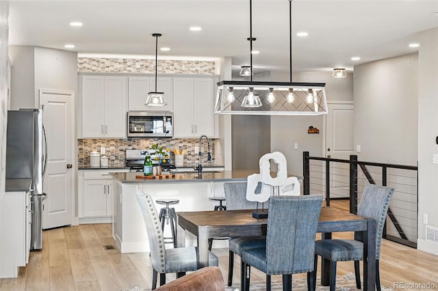 dining area with recessed lighting and light wood-type flooring