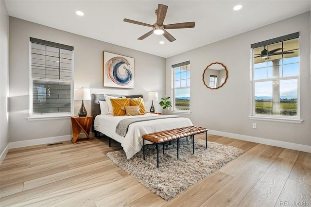 bedroom with baseboards, recessed lighting, light wood-style floors, and visible vents