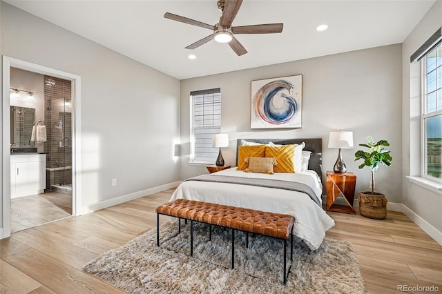 bedroom featuring baseboards, wood finished floors, and multiple windows