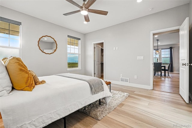 bedroom featuring visible vents, baseboards, recessed lighting, a spacious closet, and light wood finished floors