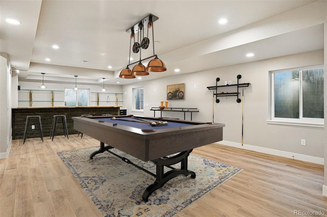 game room with baseboards, billiards, light wood finished floors, and wet bar