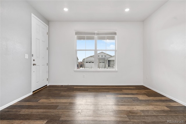 unfurnished room featuring dark wood-type flooring