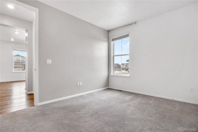 unfurnished room featuring a wealth of natural light and carpet floors