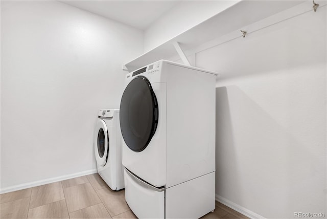 clothes washing area with separate washer and dryer