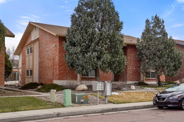 995 Holli Springs Ln, Colorado Springs, CO 80907 - view of front of property with brick siding and roof with shingles