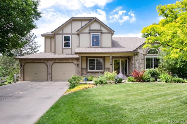 2480 W Jamison Way, Littleton, CO 80120 - tudor home with stone siding, driveway, stucco siding, and a front yard