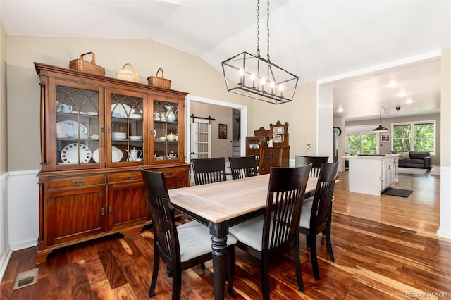 2480 W Jamison Way, Littleton, CO 80120 - dining area featuring dark wood-type flooring, a chandelier, and vaulted ceiling