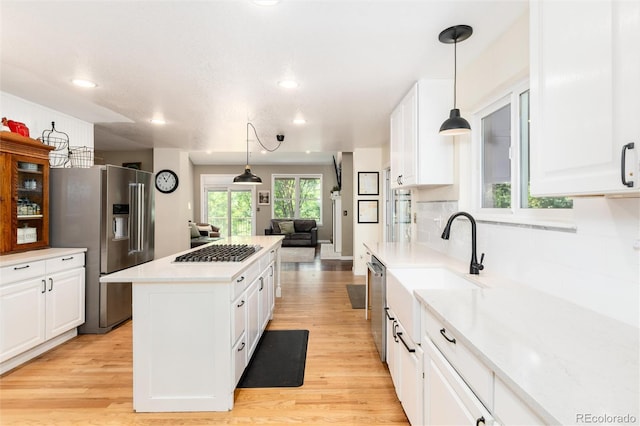 2480 W Jamison Way, Littleton, CO 80120 - kitchen with stainless steel appliances, a kitchen island, white cabinetry, recessed lighting, and light countertops