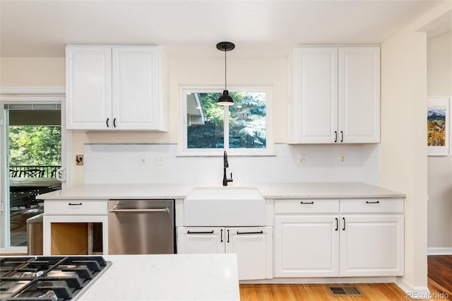 2480 W Jamison Way, Littleton, CO 80120 - kitchen with dishwasher, light countertops, and white cabinets