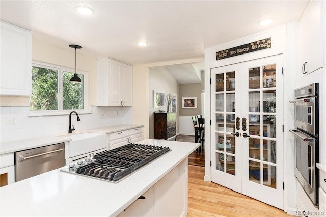 2480 W Jamison Way, Littleton, CO 80120 - kitchen featuring stainless steel appliances, light wood-style flooring, white cabinets, light countertops, and recessed lighting