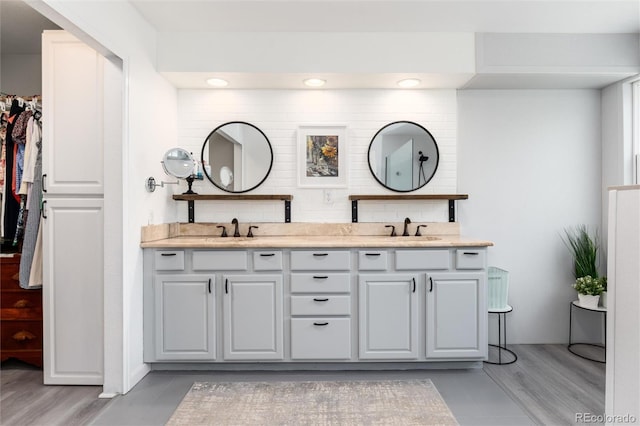 2480 W Jamison Way, Littleton, CO 80120 - bathroom featuring double vanity, wood finished floors, recessed lighting, and a walk in closet