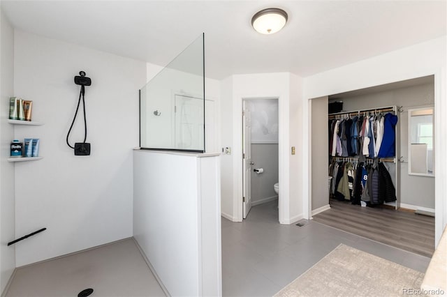 2480 W Jamison Way, Littleton, CO 80120 - bathroom featuring walk in shower and a walk in closet