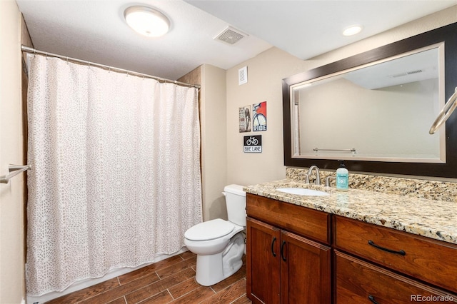 2480 W Jamison Way, Littleton, CO 80120 - full bath with wood finish floors, vanity, and a shower with curtain