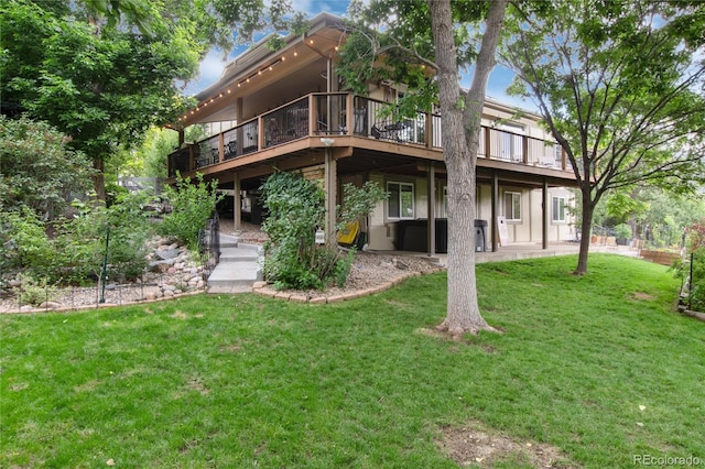 2480 W Jamison Way, Littleton, CO 80120 - rear view of house with a deck and a lawn