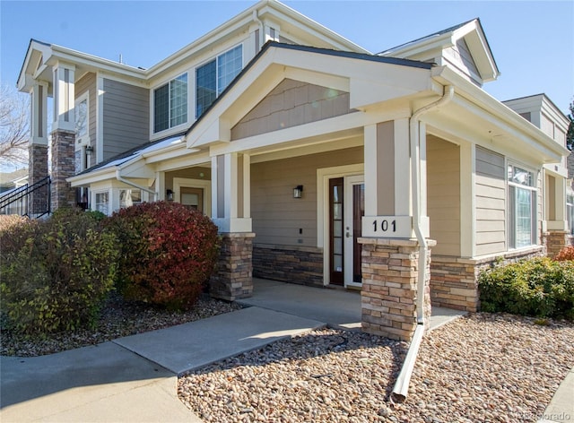 13708 Legend Trl Unit 101, Broomfield, CO 80023 - view of side of property with stone siding and a porch