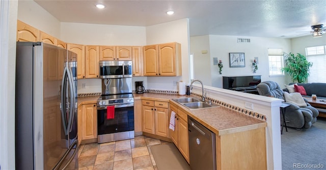 13708 Legend Trl Unit 101, Broomfield, CO 80023 - kitchen featuring light brown cabinets, a sink, and appliances with stainless steel finishes