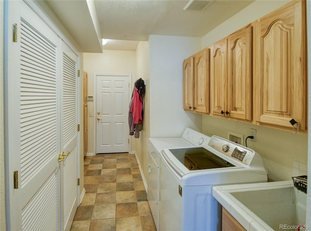 13708 Legend Trl Unit 101, Broomfield, CO 80023 - washroom with washing machine and clothes dryer, a sink, cabinet space, baseboards, and visible vents