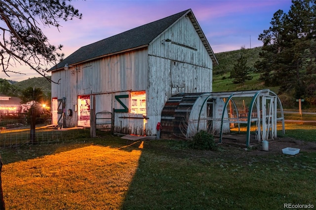 outdoor structure at dusk with a lawn