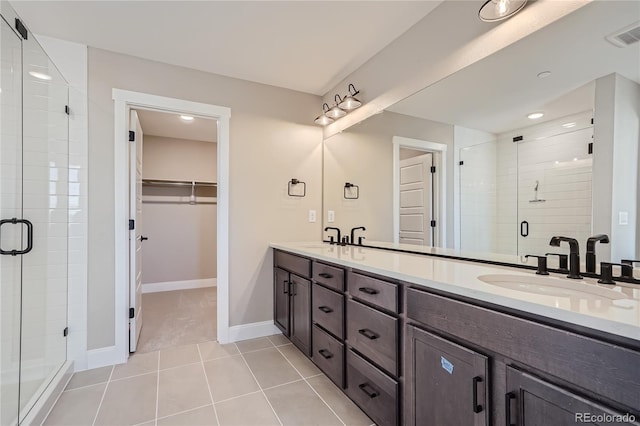 bathroom with vanity, a shower with shower door, and tile patterned flooring