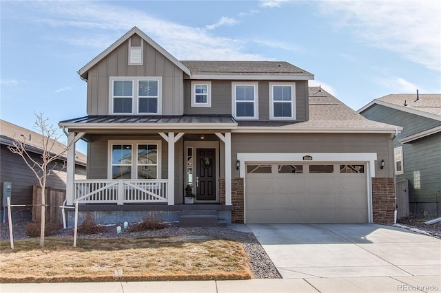 craftsman-style home with board and batten siding, concrete driveway, covered porch, and roof with shingles