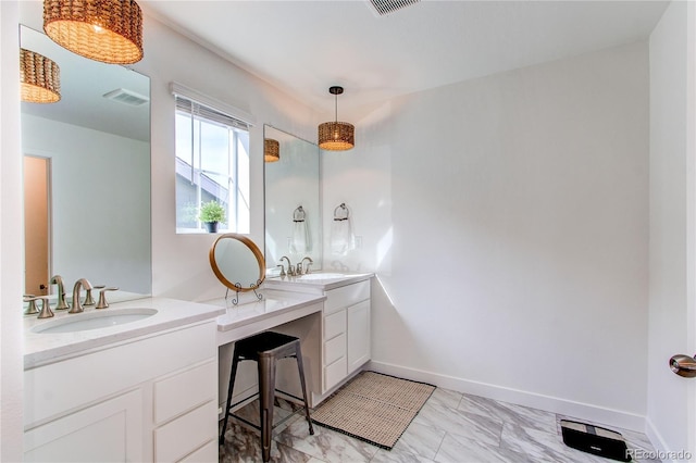 bathroom with a sink, baseboards, marble finish floor, and two vanities