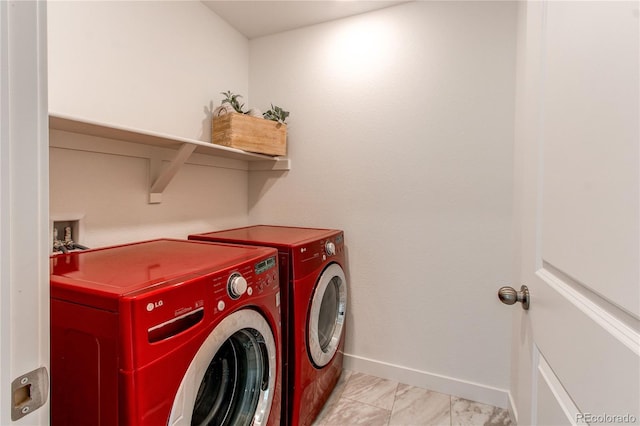 laundry room with baseboards, marble finish floor, laundry area, and washing machine and clothes dryer