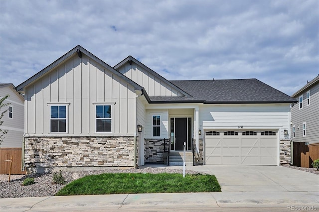 9197 Ironwood St, Highlands Ranch, CO 80129 - view of front of house with a garage, concrete driveway, board and batten siding, and stone siding