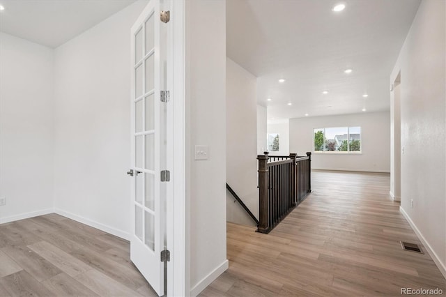 9197 Ironwood St, Highlands Ranch, CO 80129 - hallway with an upstairs landing, light wood-style flooring, and recessed lighting
