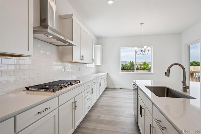 9197 Ironwood St, Highlands Ranch, CO 80129 - kitchen with wall chimney range hood, appliances with stainless steel finishes, tasteful backsplash, and light countertops