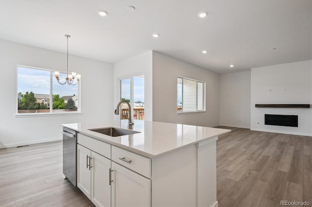 9197 Ironwood St, Highlands Ranch, CO 80129 - kitchen with stainless steel dishwasher, light wood-style flooring, light countertops, white cabinets, and recessed lighting