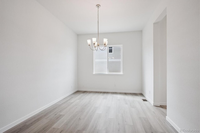 9197 Ironwood St, Highlands Ranch, CO 80129 - spare room featuring a chandelier and light wood-type flooring