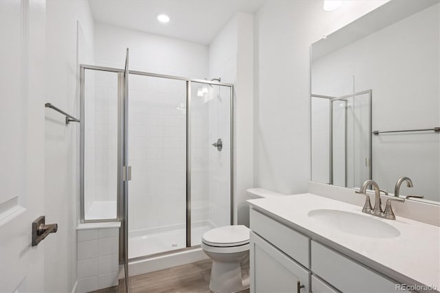 9197 Ironwood St, Highlands Ranch, CO 80129 - bathroom featuring vanity, a stall shower, and wood finished floors