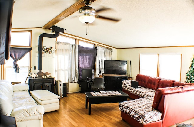 living room featuring a textured ceiling, ceiling fan, beamed ceiling, crown molding, and hardwood / wood-style flooring