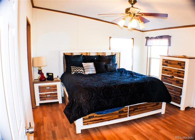 bedroom with crown molding, dark hardwood / wood-style floors, and ceiling fan