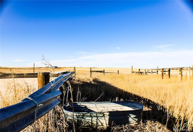 view of yard with a rural view