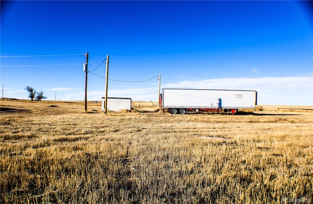 view of yard with a rural view