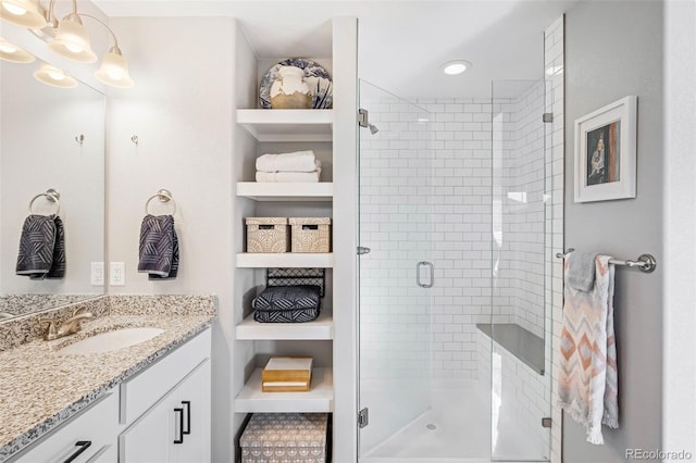 bathroom with walk in shower and vanity