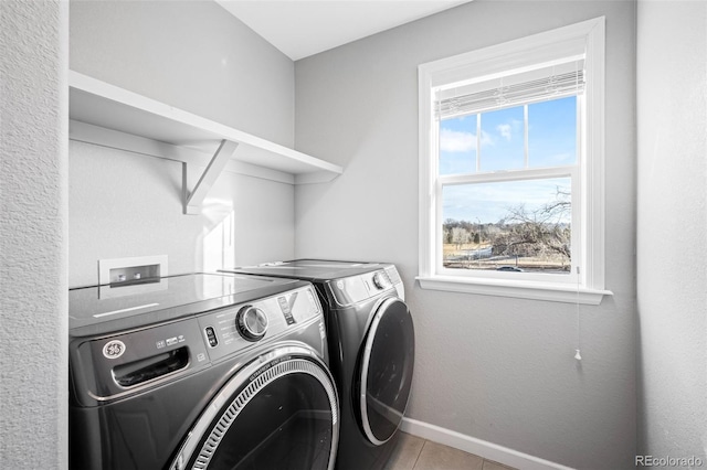 clothes washing area with washer and clothes dryer